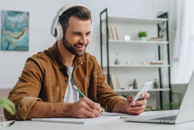 smiling-man-using-smartphone-and