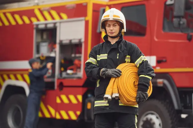 holding-fire-hose-woman-in-uniform-is-at-work-in-2023-11-27-05-02-00-utc