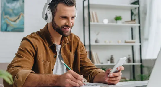 smiling-man-using-smartphone-and
