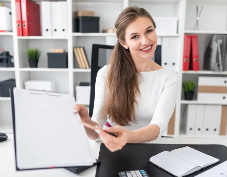 a-young-girl-sitting-at-a-table-and-shows-a-pen-on-2023-11-27-05-20-49-utc