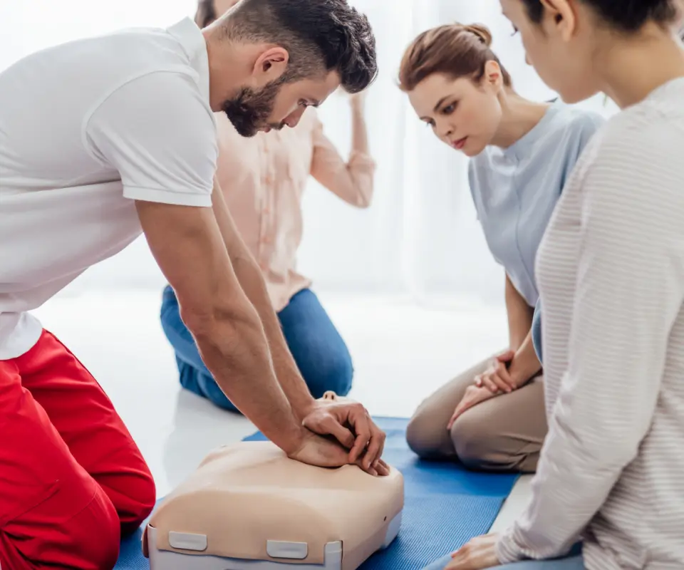 instructor-performing-cpr-on-dum