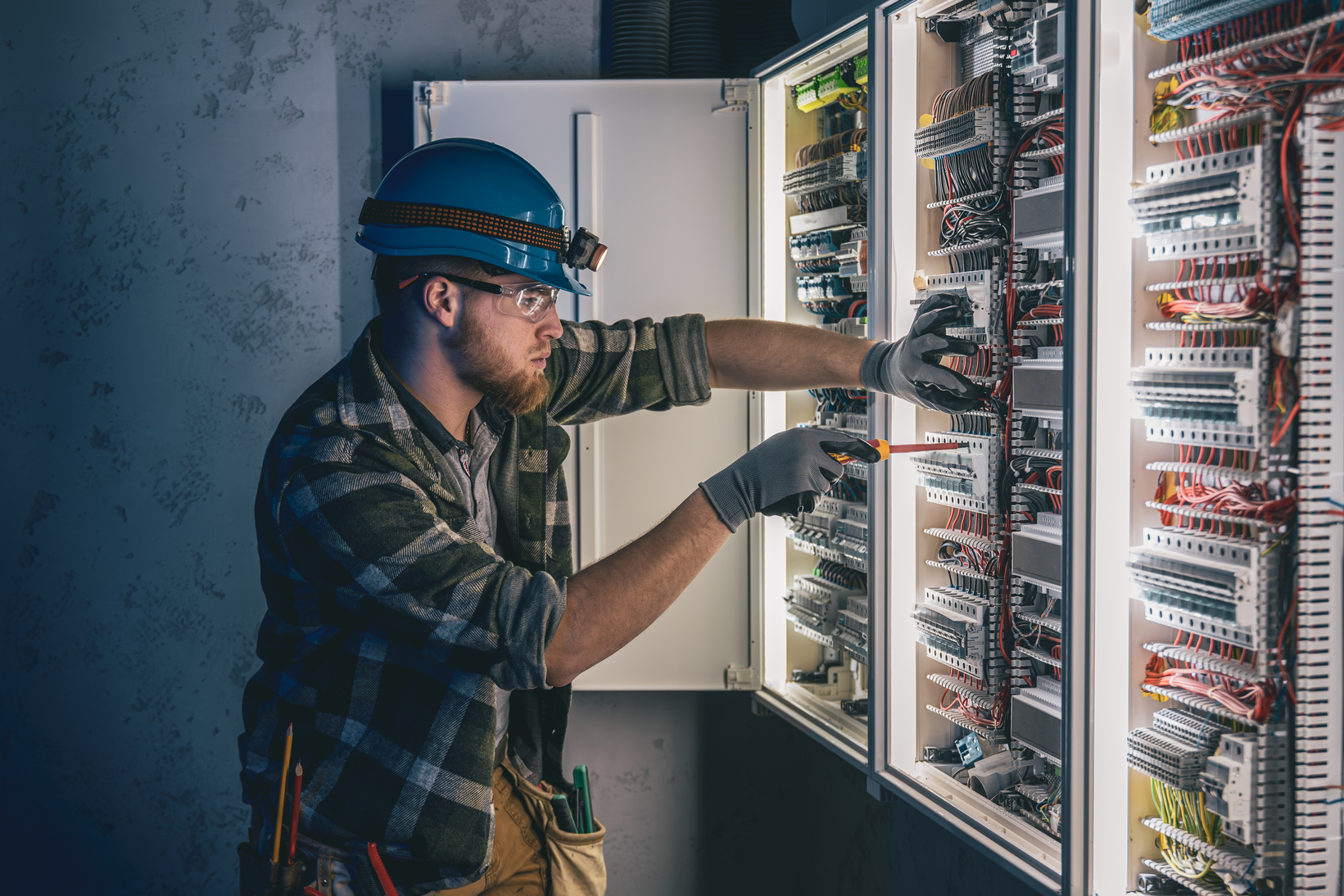 a-male-electrician-works-in-a-sw.jpg
